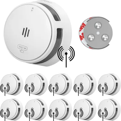 A collection of wireless smoke detectors and their mounting hardware are displayed against a white background.