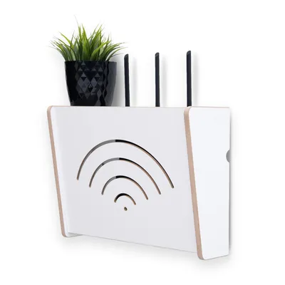 A white router stand with a plant on top, mounted on a white wall.