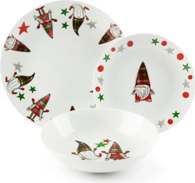 A set of white ceramic plates and bowls decorated with a Christmas gnome pattern.
