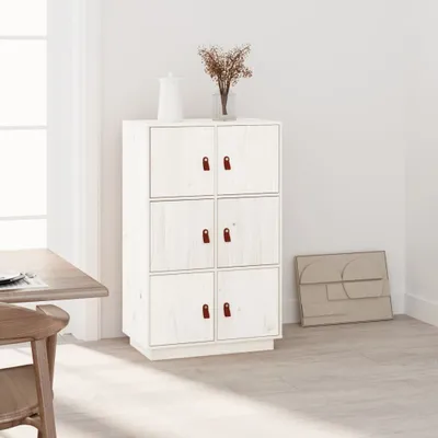 A white storage cabinet with brown handles in a room setting, next to a dining table and chair.