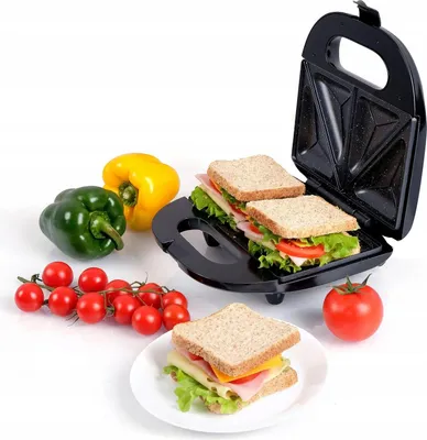 A sandwich maker with sandwiches and ingredients.