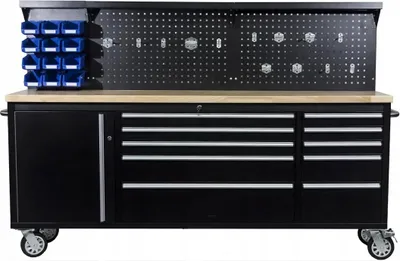 A black metal workbench with a wooden top, drawers, a cabinet, and a pegboard with storage bins.