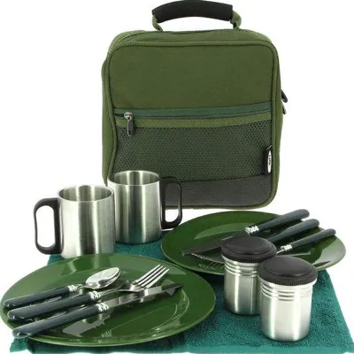 A picnic cutlery set laid out on a green towel, with a green carrying bag in the background.