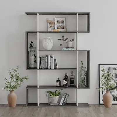 A modern, multi-level bookshelf unit with various decorative items and books displayed on its shelves, set against a plain white wall.