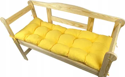 A yellow cushion on a wooden bench.