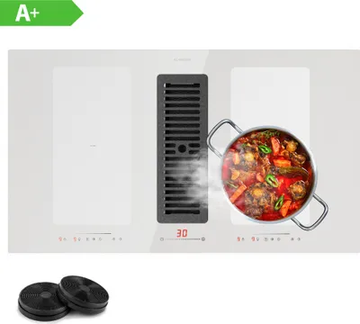 A white induction cooktop with an integrated downdraft ventilation system, featuring a pot of food cooking on one of the burners and two charcoal filters shown below.