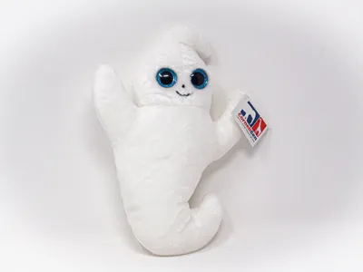 A white plush ghost toy with large blue eyes and a small smile, holding a tag in its right hand, against a white background.