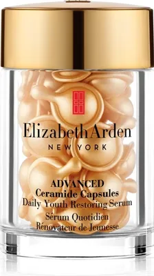 A jar filled with small, pearl-like capsules of Elizabeth Arden serum.