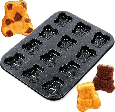 A baking pan with multiple bear-shaped molds and three baked bear-shaped cakes.