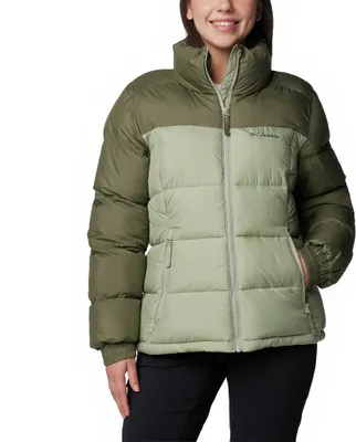 A woman wearing a green puffer jacket.