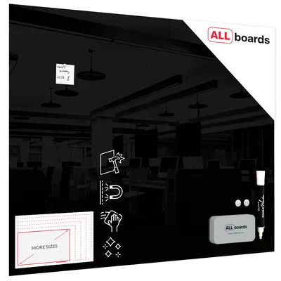 A black glasboard with accessories and marketing icons, set against a blurred office background.
