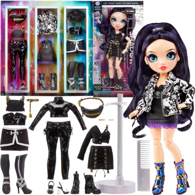 A doll with multiple outfits and accessories laid out around it, with the doll in its packaging in the background.