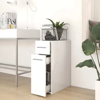 A white cabinet with drawers and a door, placed next to a desk in a room.