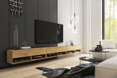 A modern living room with a TV stand, TV, sofa, and coffee table.