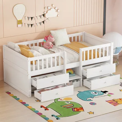 A white wooden children's bed with drawers and a railing, set up in a room with a colorful rug and wall decorations.