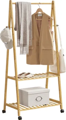 A wooden garment rack with clothes and accessories on it, displayed on a white background.