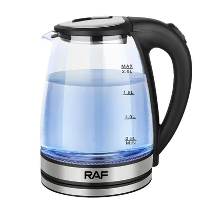 A glass electric kettle filled with blue-tinted water, sitting on a white background.