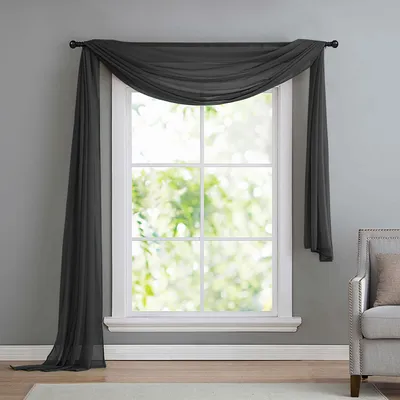 A dark gray sheer scarf draped over a window.