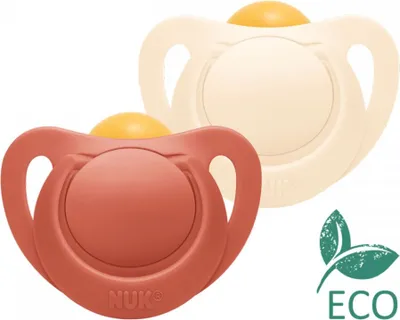 Two NUK pacifiers, one terracotta and one cream colored, are shown against a white background. An 'ECO' logo with green leaves is in the bottom right corner.