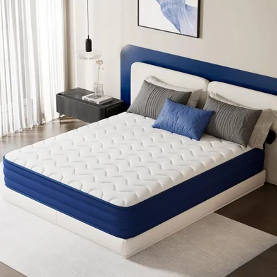 A mattress is displayed on a bed frame in a bedroom setting.