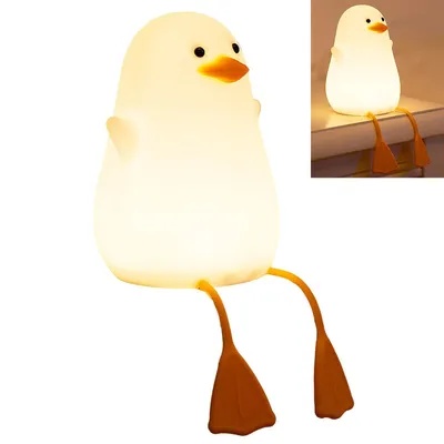 A cute duck-shaped night light with its legs dangling.