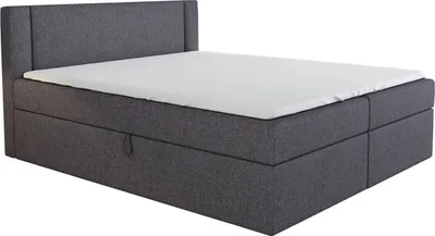 A dark gray boxspring bed with a white mattress topper is shown against a white background.