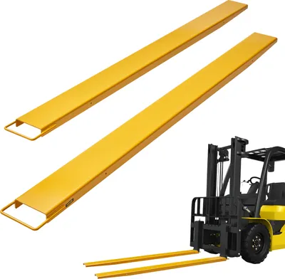 A pair of yellow forklift extensions are shown in the foreground, with a yellow and black forklift in the background.