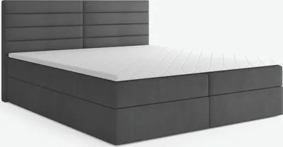 A dark gray boxspring bed with a white mattress and topper, shown from a side angle against a white background.