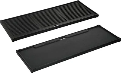 Two cast iron grill plates, one with grates and one flat, are shown on a white background.