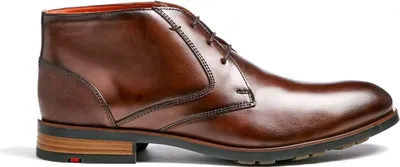 A side view of a brown leather chukka boot.