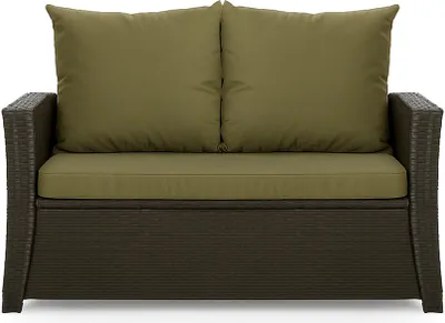A front view of a brown rattan sofa with green cushions.
