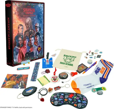 A Stranger Things advent calendar and various themed merchandise are displayed on a white background.