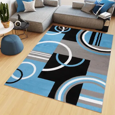 A modern living room with a sectional sofa and a rug.