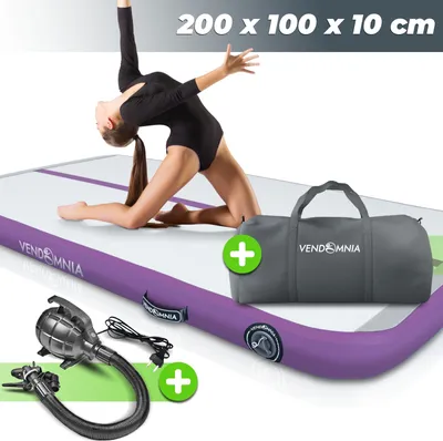 A gymnast is performing on a purple and white air track mat. A gray duffel bag and an electric pump are also shown.