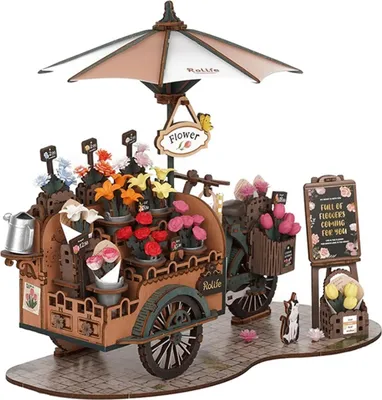 A 3D wooden model of a flower cart with an umbrella, displayed on a cobblestone-like surface.