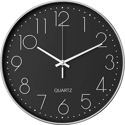 A close-up view of a black analog wall clock with white numbers and hands.