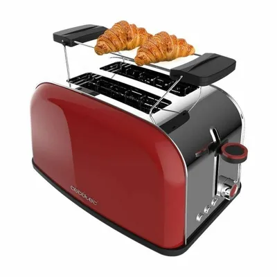 A red and silver toaster with two croissants on top.
