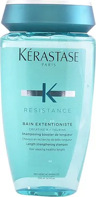 A bottle of Kerastase shampoo against a light blue background.