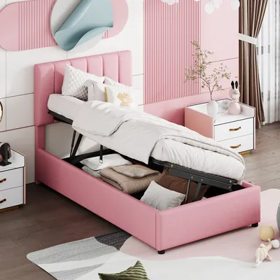 A pink upholstered bed with its storage compartment open, revealing stored items, in a bedroom setting.