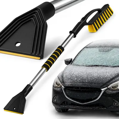 A car snow brush and ice scraper with an extendable handle, shown next to a snow-covered car.