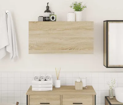 A bathroom vanity with towels, toiletries, and a mirror.
