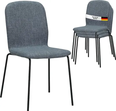 A set of four gray chairs stacked on top of each other, with one chair in the foreground and three stacked behind it. A label with the German flag and text is attached to the top chair.