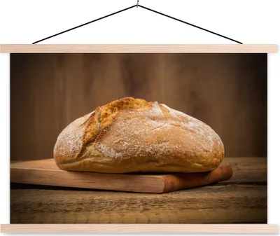 Produktbild von MuchoWow® Textilposter Ein Weißbrot vom Bäcker 120x80 cm mit holzfarbenen Rahmen - Aufhängeset