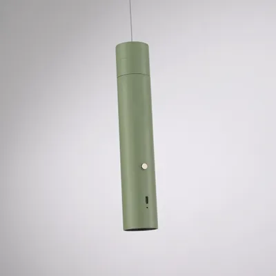 A green LED pendant light hangs from a thin wire against a plain background.