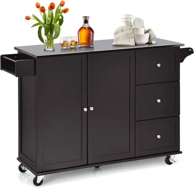 A dark brown kitchen island with a stainless steel top, shown with decorative items on top.