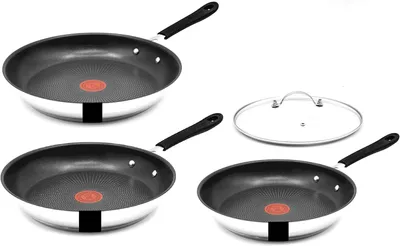 Three frying pans and one glass lid are arranged on a white background.