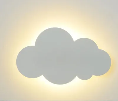 A cloud-shaped wall lamp emitting warm white light against a wall.