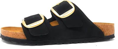 A black Birkenstock sandal with a large gold buckle.