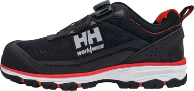 A side view of a black work shoe with red and white accents.