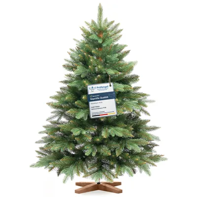 A full shot of an artificial Christmas tree with a tag attached.